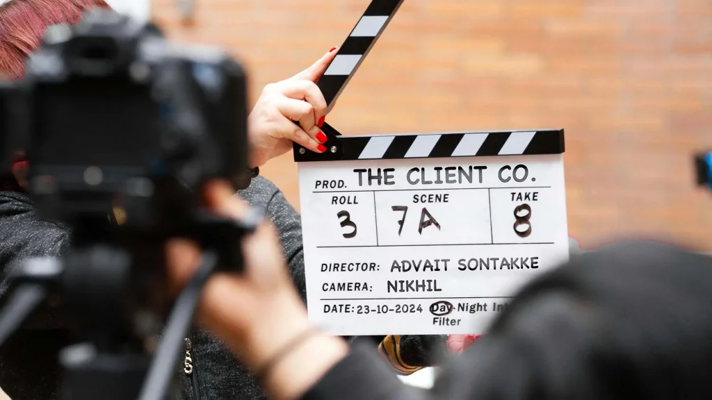 Professional filmmaking clapperboard with branding, representing corporate video production services in Mumbai.